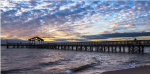 Photo of pier and ocean at sunset (Photo Credit: Ping Sun, Office of Inspector General).